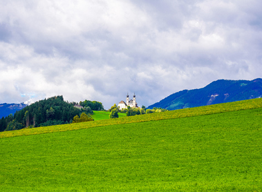 View of the Frauenberg pilgrimage church on the Enns and the surrounding landscape. Historic Christian church in the Ennstal in the town of Frauenberg.